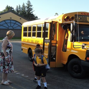 Mrs. Wagner welcomes students as they come off the bus.