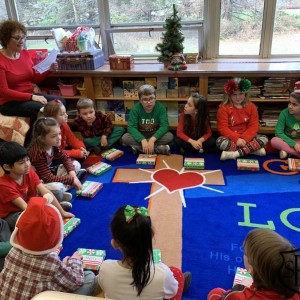 Classroom prayers before sharing gifts with classmates.