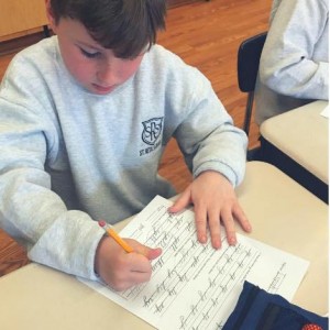 Students work hard at improving their cursive skills.
