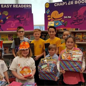 Spring Book Fair raffle winners show off their prizes.